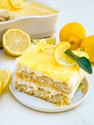 A closer view of a slice of Limoncello Tiramisu with the distinct layers, on a small plate.