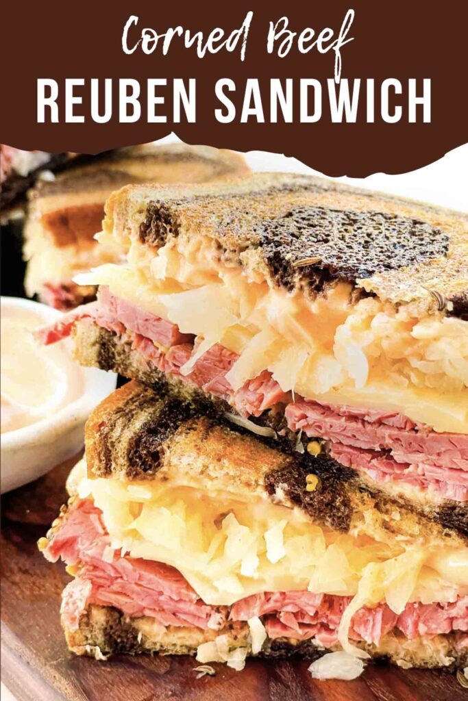 Pin of a cut Pastrami Reuben Sandwich Recipe stacked up with title.