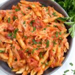 Looking down on a bowl of Chicken alla Vodka Pasta with fresh parsley.