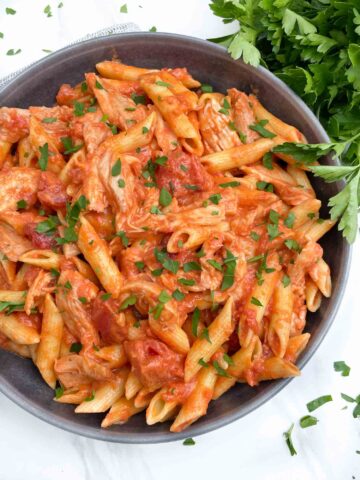 Looking down on a bowl of Chicken alla Vodka Pasta with fresh parsley.