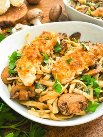 A closer view of Copycat Olive Garden Chicken Marsala Fettuccine pasta in a bowl.