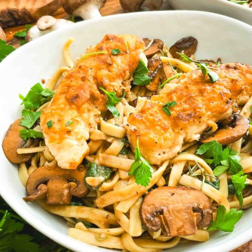 A closer view of Copycat Olive Garden Chicken Marsala Fettuccine pasta in a bowl.
