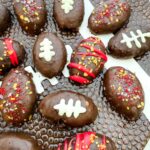 Football Cake Pop bites decorated with team colors and as footballs, on a football plate.