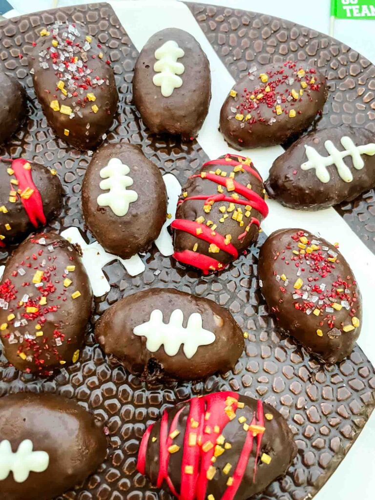 Football Cake Pop bites decorated with team colors and as footballs, on a football plate.