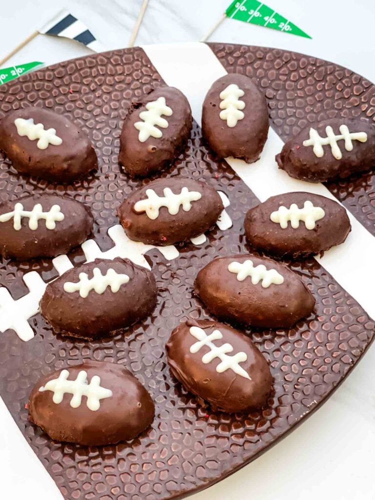 Pieces of Football Cake Pops on a football plate.