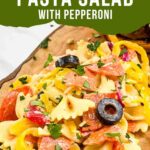 Pin of Italian Pasta Salad with Pepperoni on a wood board with title at top.