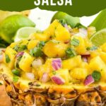 Pin of Pineapple Mango Salsa in a piece of hollowed out pineapple with title at top.