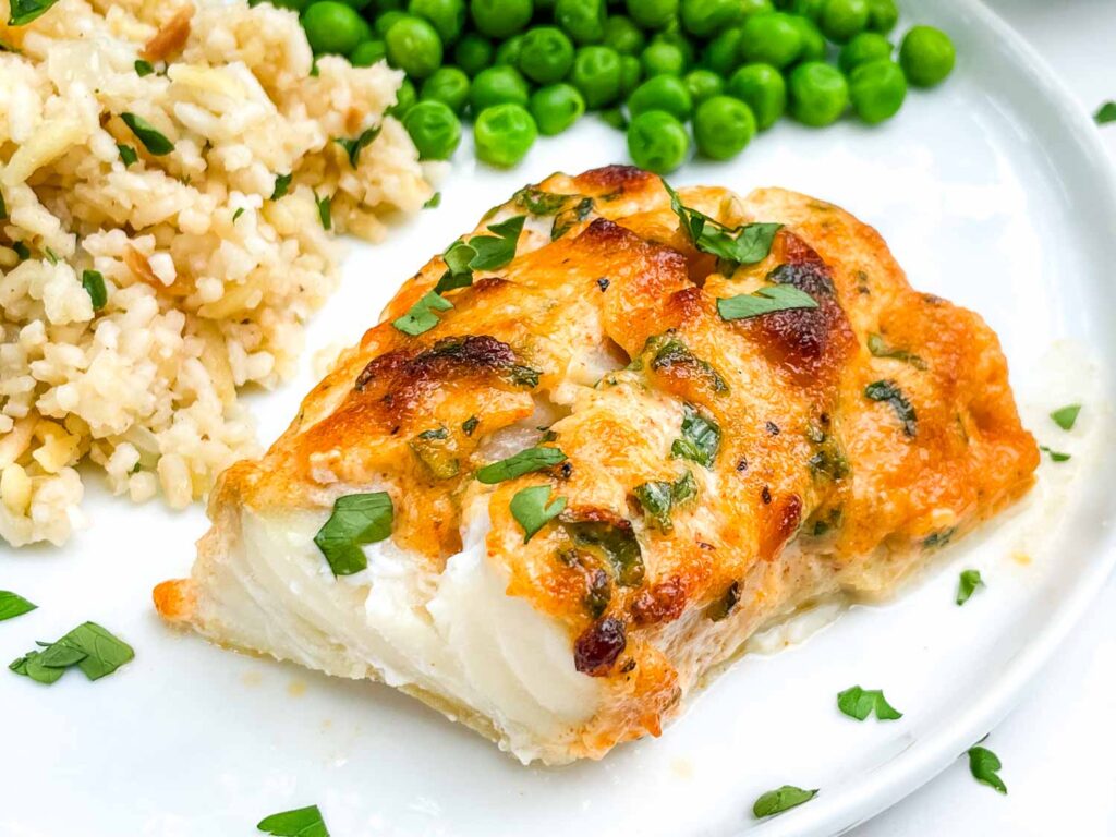 A piece of Parmesan Baked Cod on a plate.