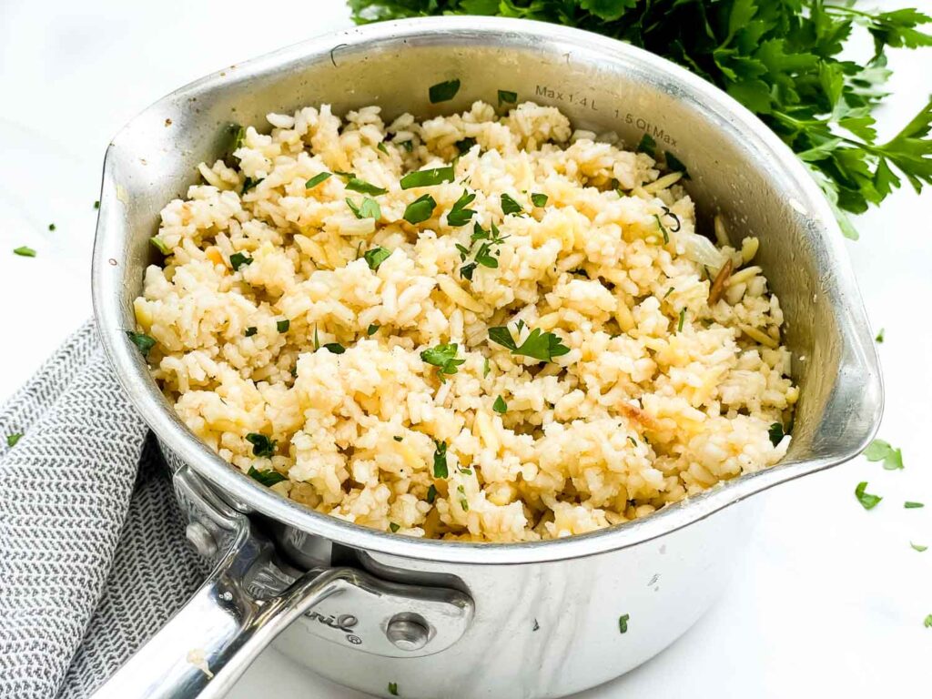 Herbed Rice Pilaf with Orzo in a silver pot on a counter.