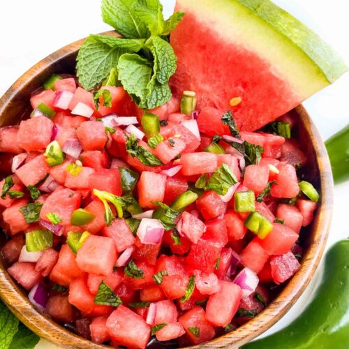 Looking down on Watermelon Salsa in a wood bowl on a counter.