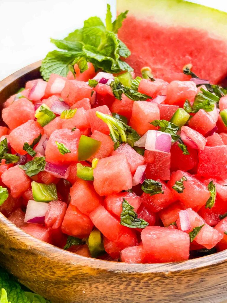 A close view of Watermelon Salsa in a wood bowl.