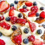 Pin of Mixed Berry French Toast pieces on a white plate with title at top.