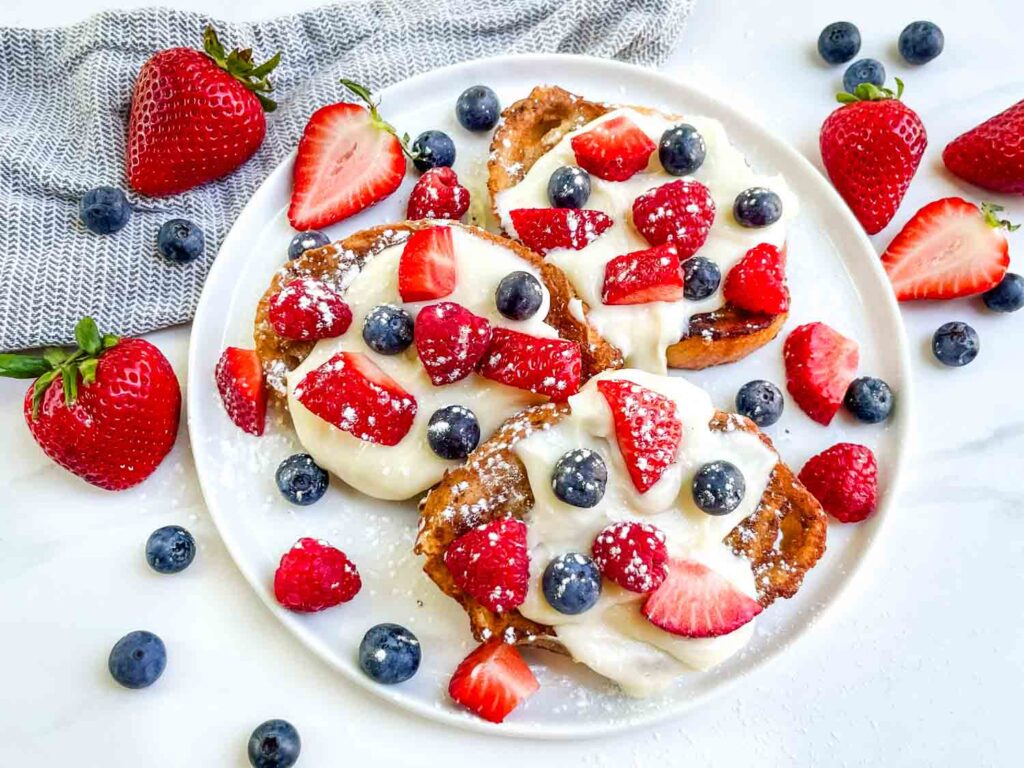 Looking down on a plate of Mixed Berry French Toast on a counter.