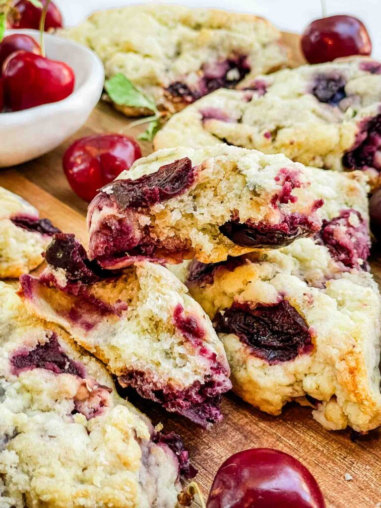 The inside of a cherry scone piled on top of others.