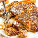 A fork digging into cut up Panettone French Toast Recipe on a plate.