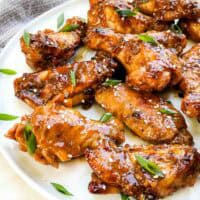 A plate with a pile of Thai Chicken Wings on it.