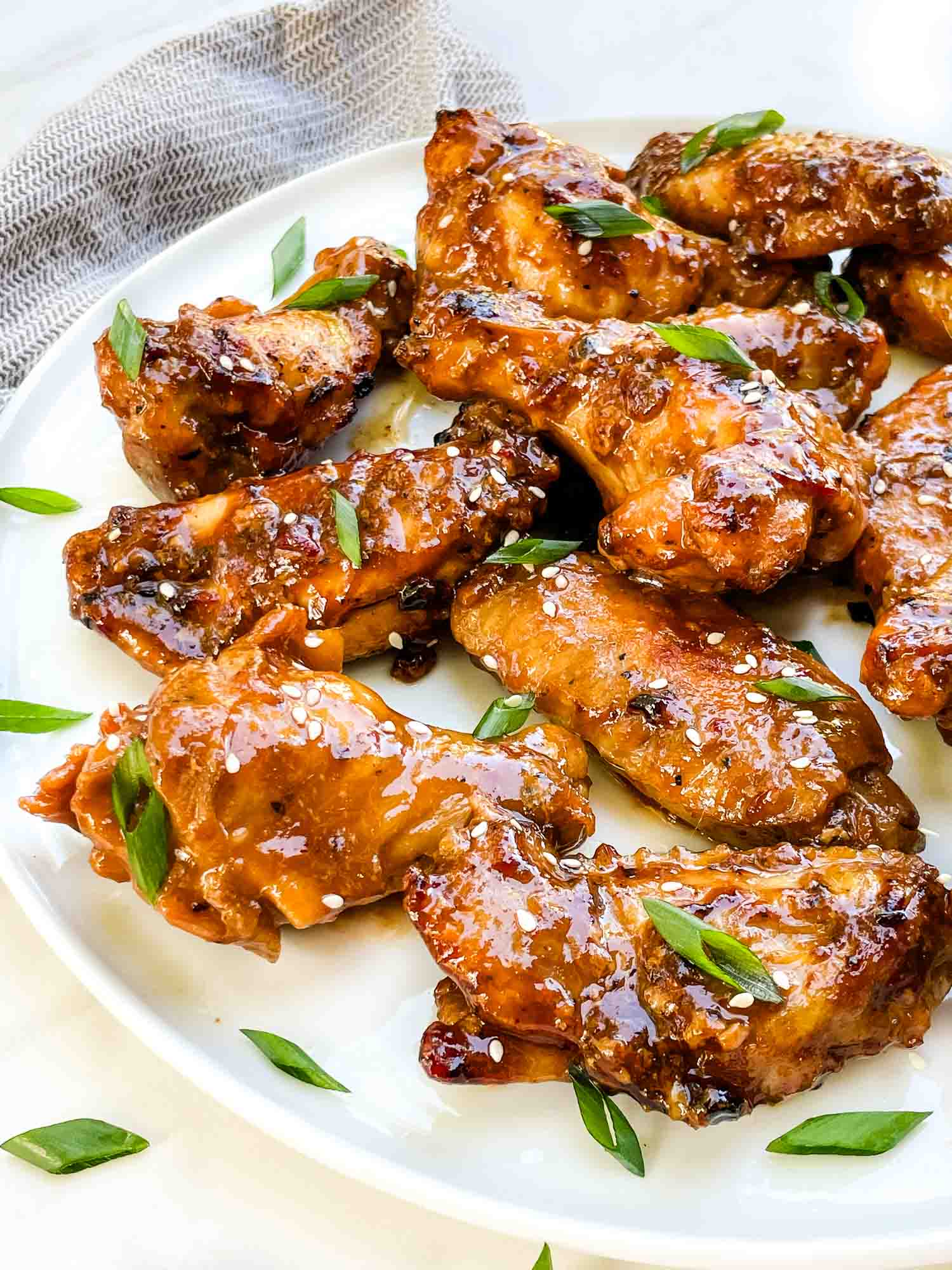 A plate with a pile of Thai Chicken Wings on it.