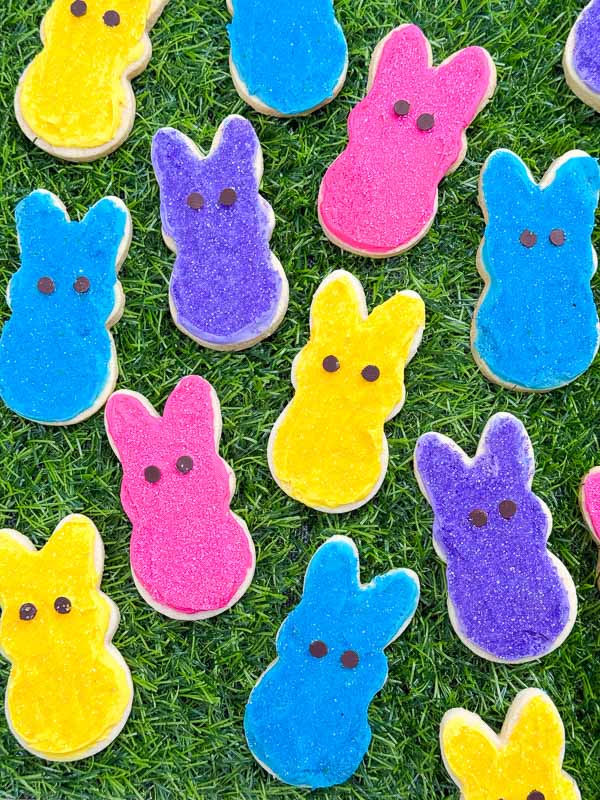 The Peeps Bunny Easter Sugar Cookies laid out across grass.