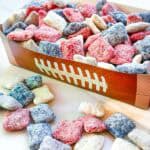 New England Patriots Puppy Chow in red, blue, white, and gray in a football container on a counter.