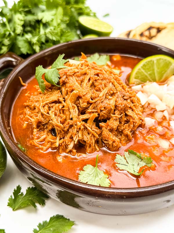 A close view of Chicken Birria (Birria de Pollo) in a dish.