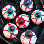 A close view of Halloween Eyeball Cake Pops on a black tray.