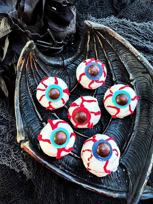 A bat wing shaped dish with Halloween Eyeball Cake Pops on it.