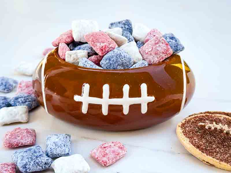 A football dish holding Houston Texans Puppy Chow on a counter.