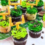 A collection of Touchdown Cupcakes grouped together on a table.