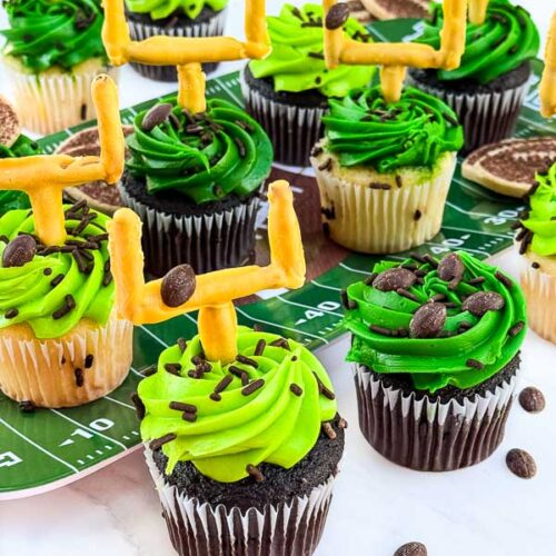 A collection of Touchdown Cupcakes grouped together on a table.