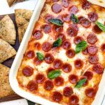 A closer view looking down on Pepperoni Pizza Dip in a small dish.